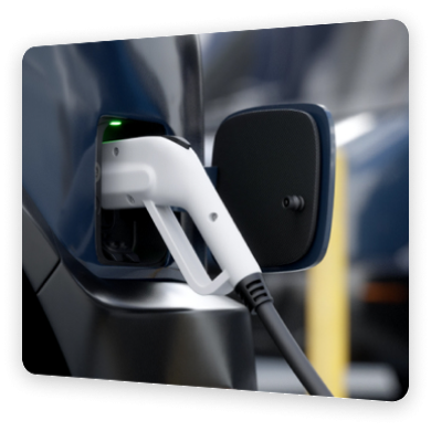 Close-up of an electric vehicle being charged, with the charging plug connected to the car.